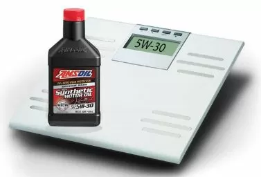 A bottle of AMSOIL motor oil next to a scale.