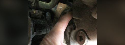 Insert a finger into the fill port and feel for the fluid level.