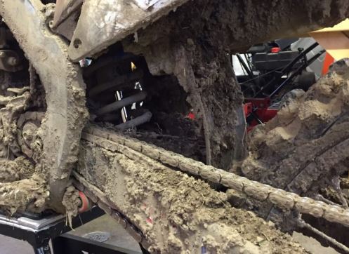 The dirt bike chain is covered in mud