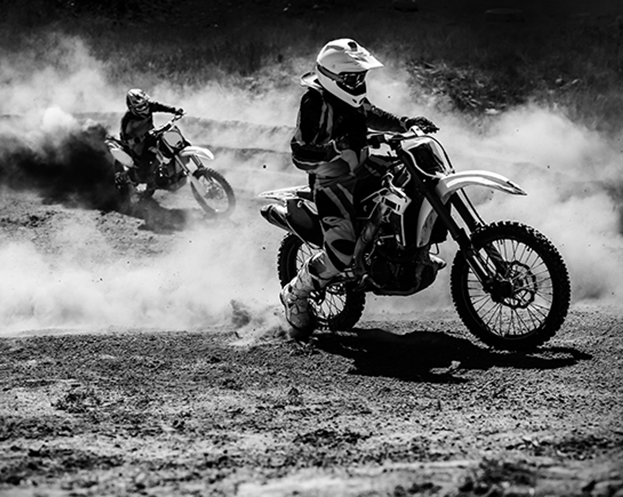 Motocross racer accelerating in dust track, Black and white, high contrast photo